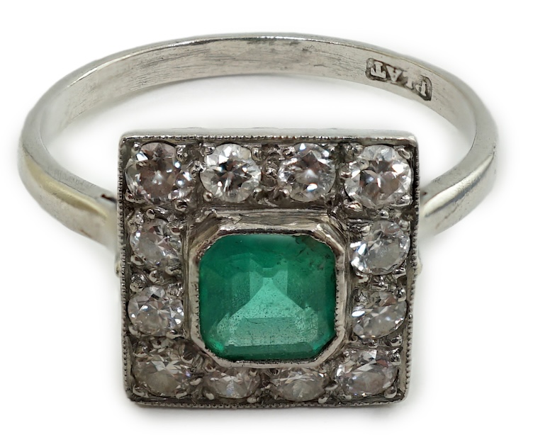 A 1930's/1940's platinum, emerald and diamond cluster set tablet ring